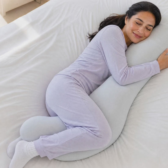 Side sleeper snuggling into the Snuggl Body Pillow