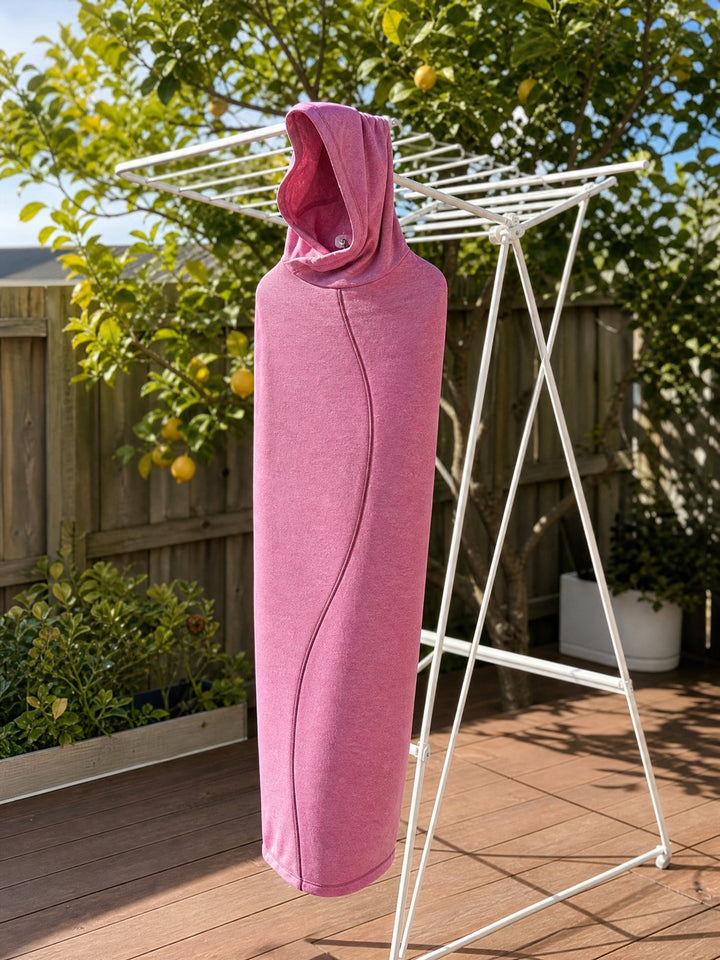 Pink Snuggl Pod drying on a clothes airer in the sun